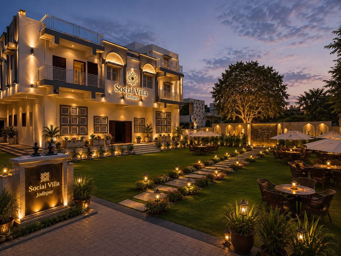 Social Villa Jodhpur exterior at dusk with lit façade, lawn and garden dining